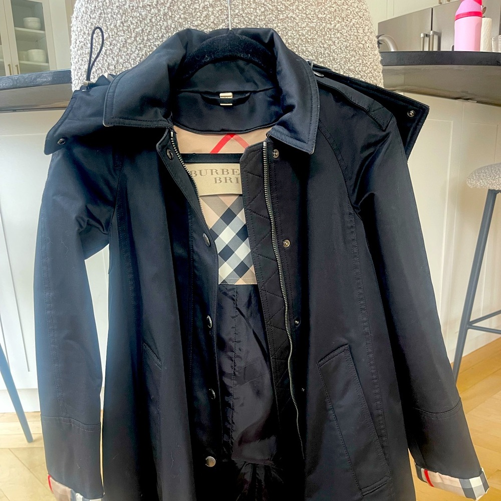 Elegant black fabric with tan label detail. Classic Burberry style.